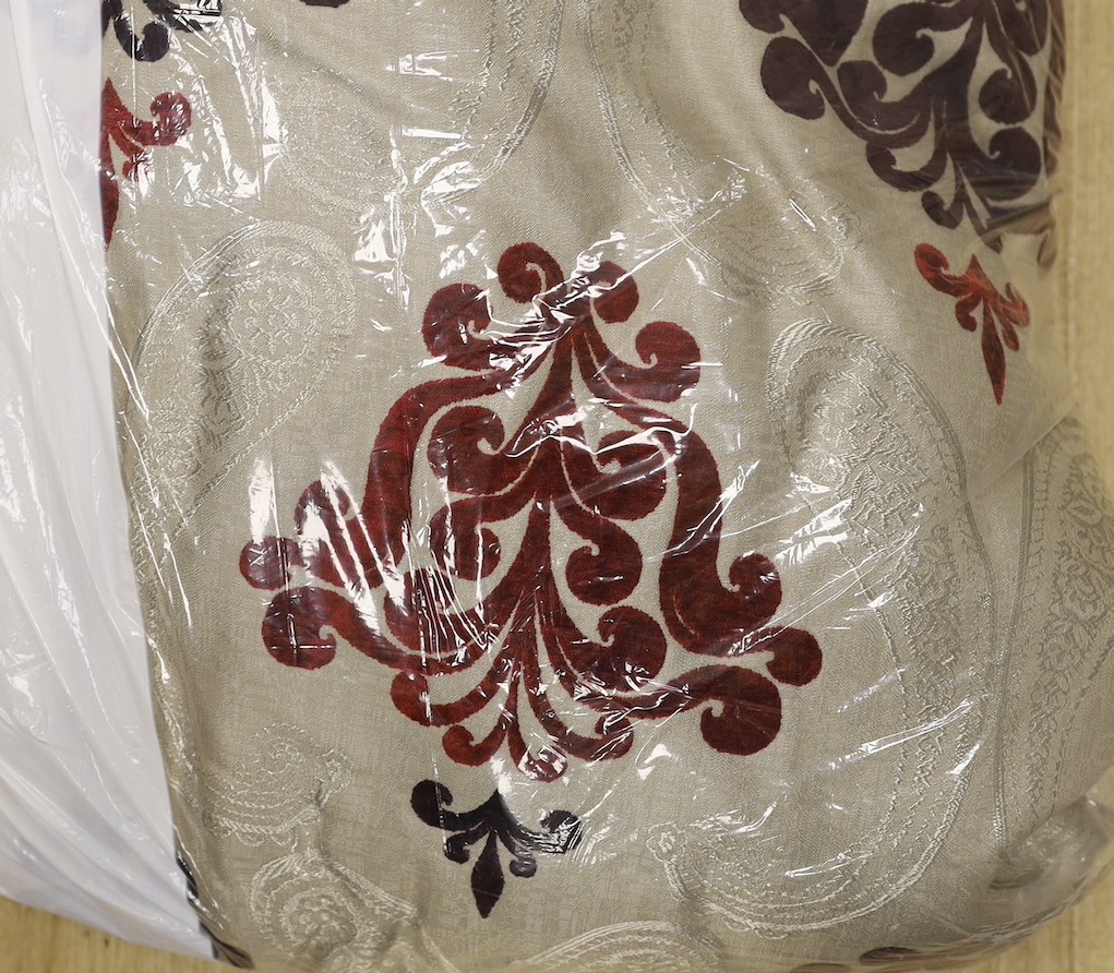 A large pair of silver brocaded curtains, with a woven paisley tear drop motif and large all over plum cut velvet Fleur-de-lis motifs, together with matching corded and tasselled tie backs.